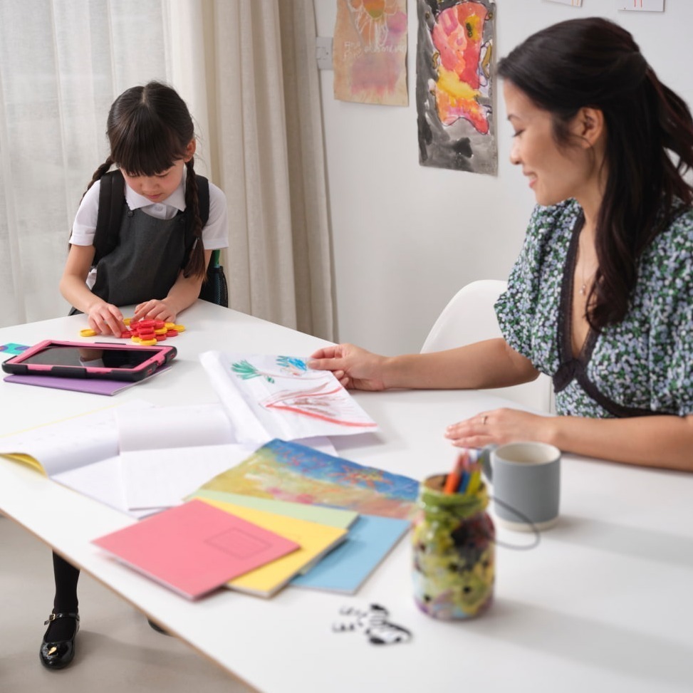 Mother and daughter filling in worksheet