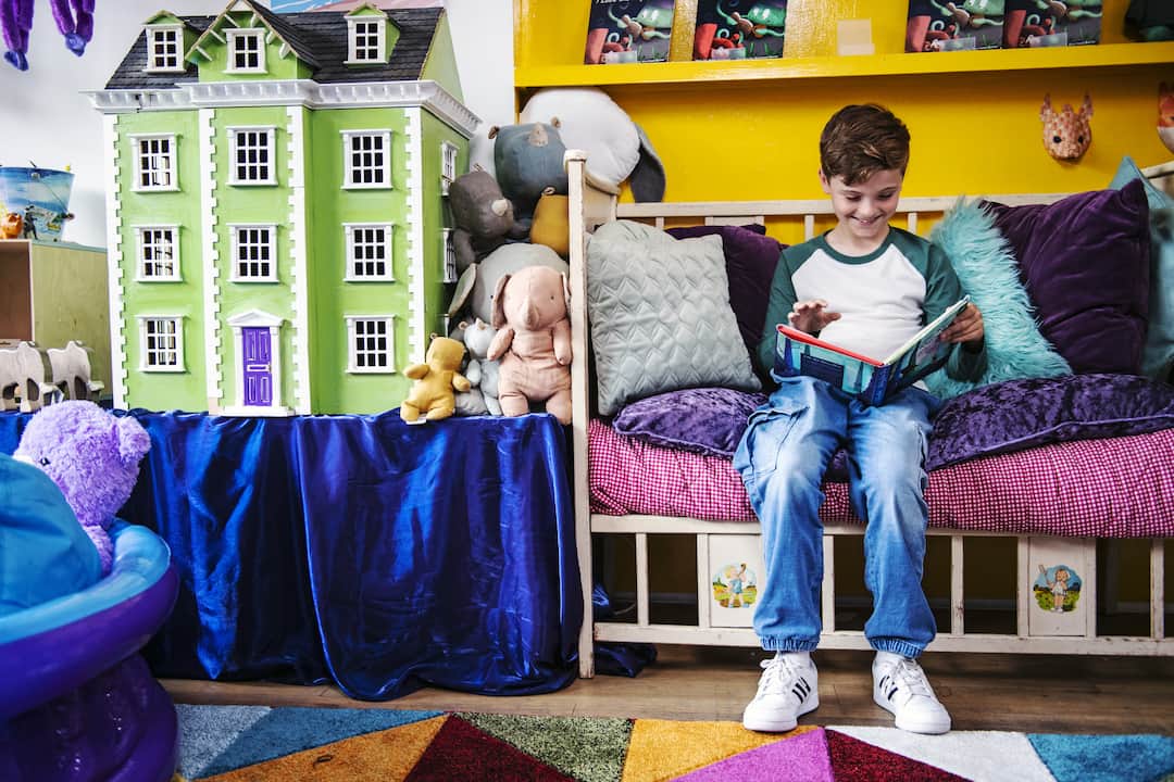 child reading in a playroom
