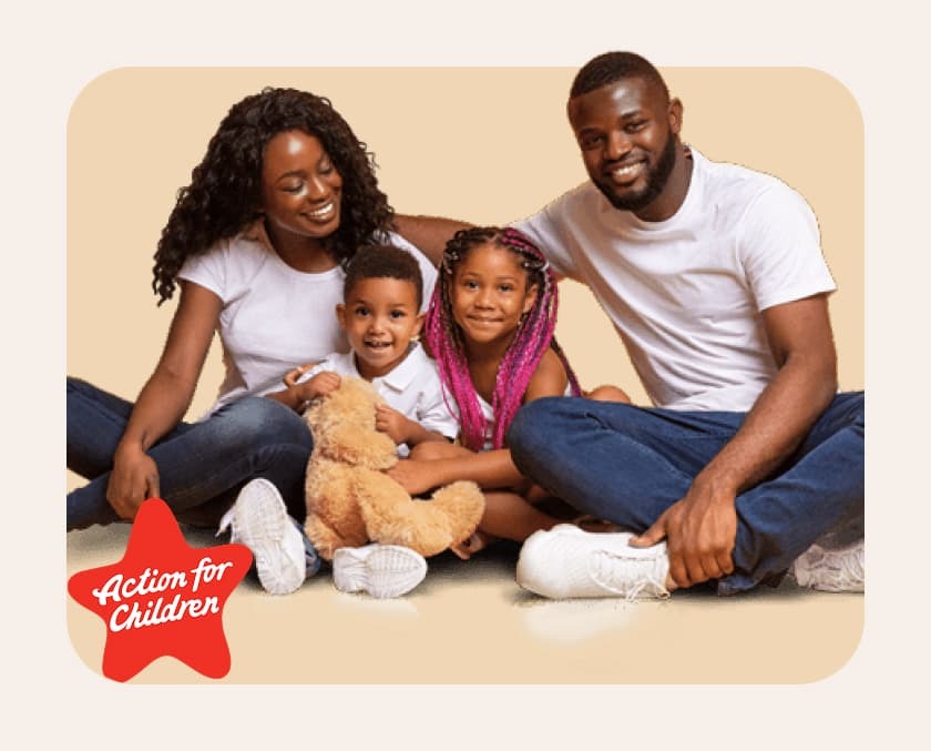 smiling family sat cross legged on the floor